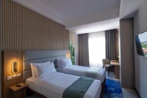 A bed or beds in a room at Oakwood Merdeka Bandung