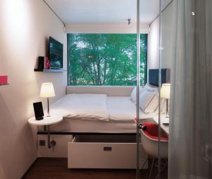 A bed or beds in a room at citizenM Amsterdam South