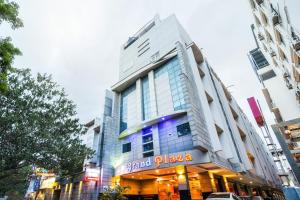 a building with a sign on the front of it at Capital O Grand Plaza in Coimbatore