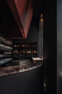 a bar with a counter with bottles of wine at Hotel Portinari in Bruges