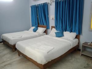 A bed or beds in a room at MJ Residency