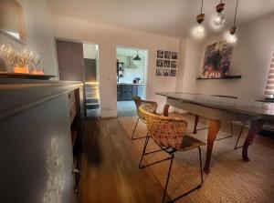 a kitchen and dining room with a table and chairs at Godi's House in Vianden