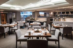 a restaurant with tables and chairs and a bar at Hilton Washington DC Capitol Hill in Washington