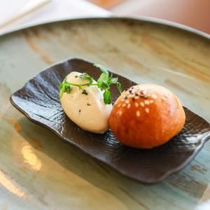 a plate of food with an egg and an orange at Hotel Aro Palace in Braşov