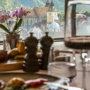 a table with a window with a view of a city at Hotel Aro Palace in Braşov