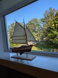 a small sail boat on a window sill at Rose & Thistle B&B Lunenburg in Lunenburg