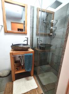 a bathroom with a sink and a glass shower at Апартамент Four Seasons in Bansko