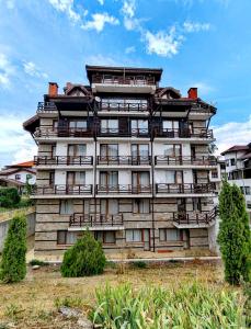 a tall building with chairs in front of it at Апартамент Four Seasons in Bansko