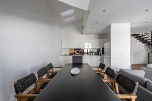 a dining room with a black table and chairs at PENTHOUSE BY GONDOLA 50 Meters, New Gudauri Suites in Gudauri