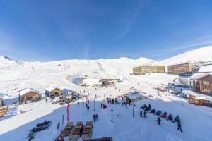 a group of people in the snow on a ski slope at PENTHOUSE BY GONDOLA 50 Meters, New Gudauri Suites in Gudauri