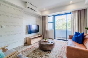 a living room with a couch and a tv at STAY Menlyn in Pretoria