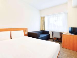 Kama o mga kama sa kuwarto sa Comfort Inn Himeji Yumesakibashi