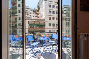 a view of a balcony with blue chairs and a table at Hostly- Don Bosco Light Lodge in Rome