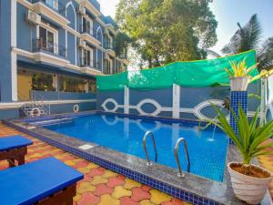 a swimming pool in the middle of a building at home and beyond by myroom in Goa