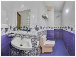 a blue and white bathroom with a toilet and a sink at home and beyond by myroom in Goa