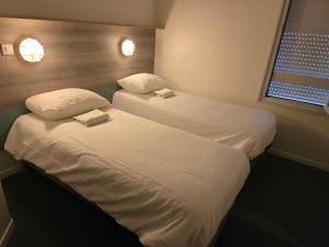 Säng eller sängar i ett rum på Stay Inn poitiers