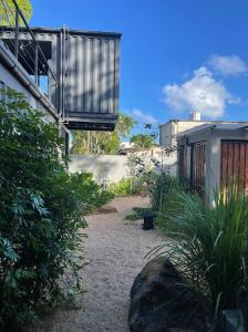 een tuin met een balkon aan de zijkant van een gebouw bij OBOĒ Gardenstē in Pereybere