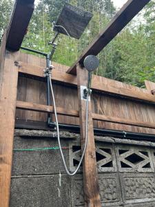 a shower is attached to a wooden fence at 一日限定一組の宿なんでもん in Naoshima