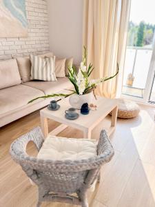 a living room with a couch and a table at Apartament Aqua Przystań 80 - Rumia Novum in Rumia