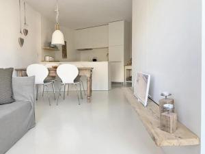 cocina y sala de estar con mesa y sillas en Chesa Auricula, en Pontresina