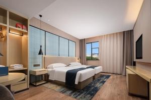 Cama ou camas em um quarto em Echarm Hotel Wuhan Optics Valley Software Park Juran Home