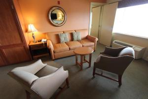 a living room with a couch and chairs and a table at InnSeason Resorts HarborWalk in Falmouth