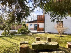 a house with a stone bench in the yard at Apartmány Lipno-Hory in Horní Planá