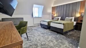 a hotel room with two beds and a window at Hotel Korona Spa & Wellness in Lublin