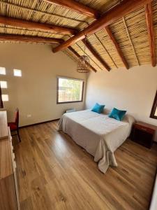 1 dormitorio con 1 cama grande con almohadas azules en Pucara Lodge 03 - 2D, en Tilcara