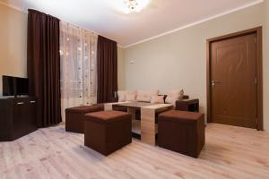 a living room with a couch and a table and stool at Family Hotel Relaxa in Sapareva Banya