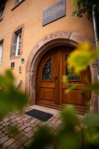 a wooden door on the side of a building at Maison Rebleuthof Sauna & Fitness in Riquewihr