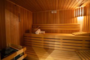 a wooden sauna with a bench in the middle at Maison Rebleuthof Sauna & Fitness in Riquewihr