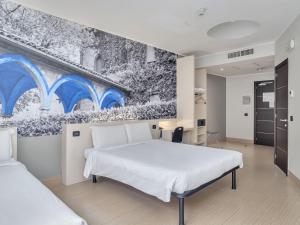 Krevet ili kreveti u jedinici u objektu B&B Hotel Como Camerlata