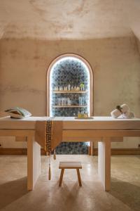 a large table in a room with a window at Hôtel Singulier Bordeaux - Boutique Hôtel & Spa Anne Semonin in Bordeaux