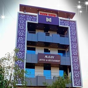 a building with a sign on the side of it at MAAN Hotel in Alwar