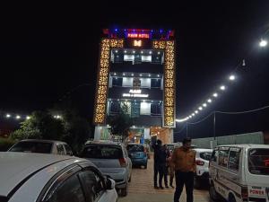 a tall building with lights on it at night at MAAN Hotel in Alwar