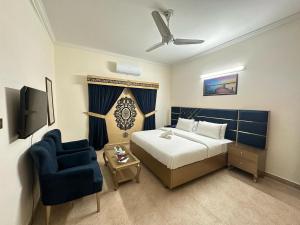 una camera d'albergo con letto e sedia blu di Dream Inn Guest House a Islamabad