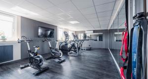 a gym with several exercise bikes in a room at PLAZA Premium Columbus Bremen in Bremen