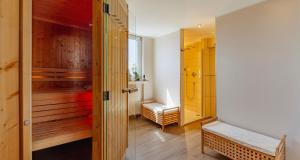 a room with a sauna with a bench in it at PLAZA Premium Columbus Bremen in Bremen