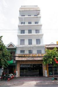 a large white building with a hotel sign on it at Khách Sạn Như Mai in Quang Tri