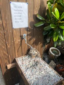 a small bird sitting on top of a wooden table at 一日限定一組の宿なんでもん in Naoshima