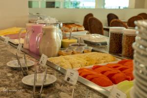 a buffet with different types of food on a table at Rede Andrade Solmar in João Pessoa