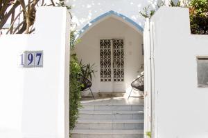 une porte menant à une maison blanche avec des escaliers dans l'établissement Pousada Maria Maria, à Salvador