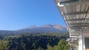 a view of mountains from the balcony of a building at JABAAL GUEST HOUSE and RESTO in Senaru