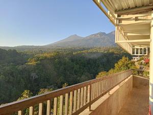 a balcony of a house with a view of a mountain at JABAAL GUEST HOUSE and RESTO in Senaru