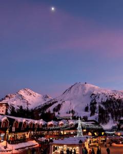 a town covered in snow with a mountain in the background at Il Fraitevino hotel bed & breakfast in Sestriere