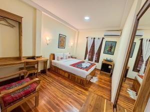 Luang Phasouk Hotel में एक कमरे में एक या कई बेड