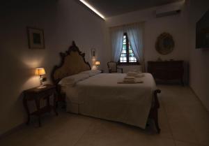 a bedroom with a large bed and a window at Casa di Anna in Pistoia