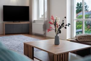 a living room with a vase with flowers on a table at Inselglück in Altefähr