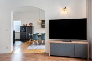 a living room with a large flat screen tv on a stand at Inselglück in Altefähr